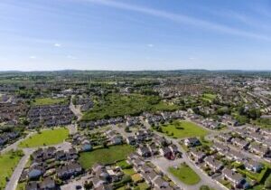 aerial birds eye view of ennis town in county clare ireland. housing estate in a scenic park setting.